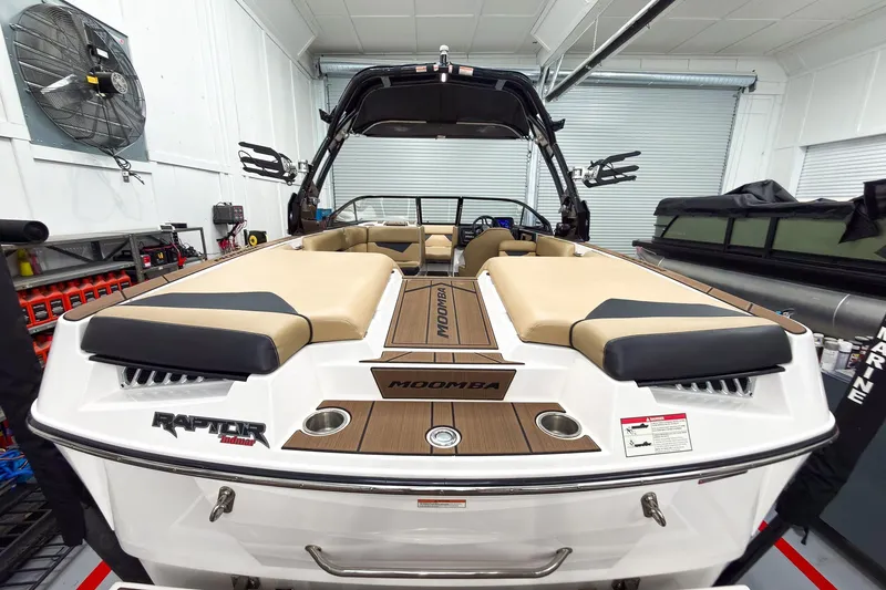 Slide: The Image of 2020 Moomba Kaiyen boat in a garage, featuring tan seating and Raptor engine branding. - 11