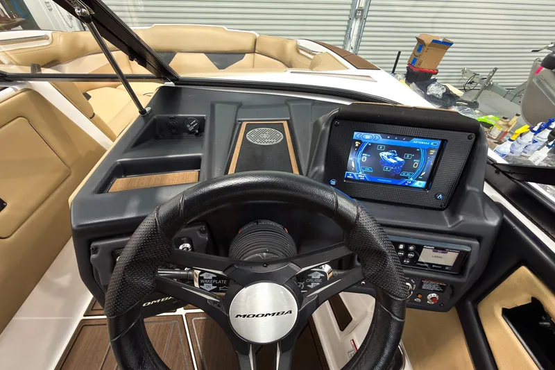Slide: The Image of 2020 Moomba Kaiyen boat dashboard with touchscreen display and steering wheel. - 18