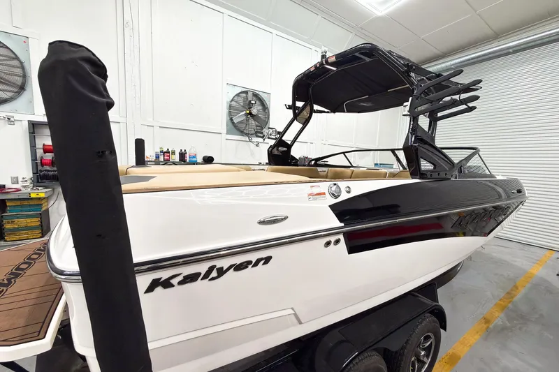 Slide: The Image of 2020 Moomba Kaiyen boat in a garage, showcasing sleek design and modern features. - 2