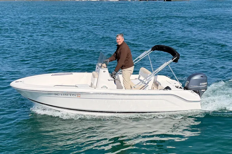Slide: The Image of 2020 Robalo R160 Center Console boat cruising on blue water. - 1