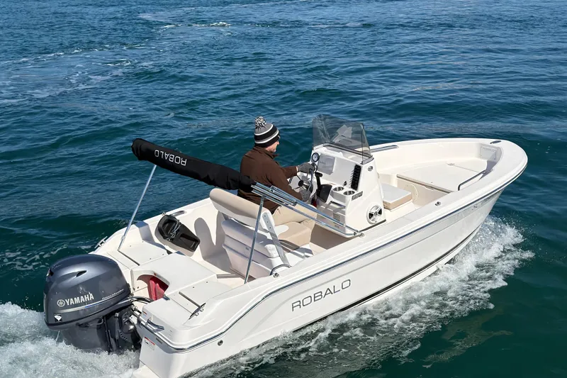 Slide: The Image of 2020 Robalo R160 Center Console boat cruising on open water. - 10