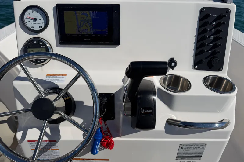 Slide: The Image of 2020 Robalo R160 Center Console boat dashboard with steering wheel and controls. - 13
