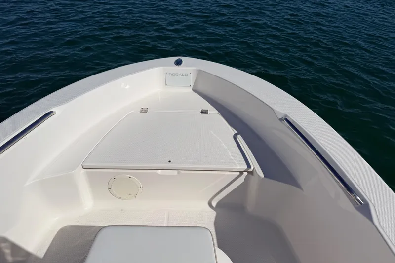 Slide: The Image of 2020 Robalo R160 Center Console boat bow on calm water. - 14