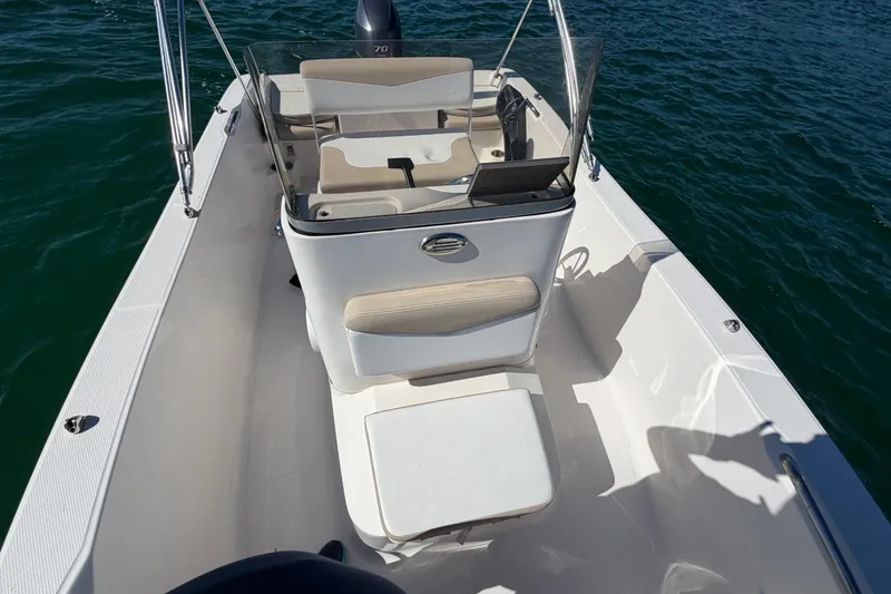 Slide: The Image of 2020 Robalo R160 Center Console boat on water, featuring spacious deck and seating. - 17