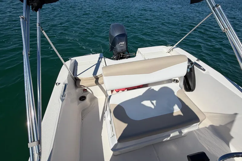 Slide: The Image of 2020 Robalo R160 Center Console boat on water, featuring seating and outboard motor. - 22