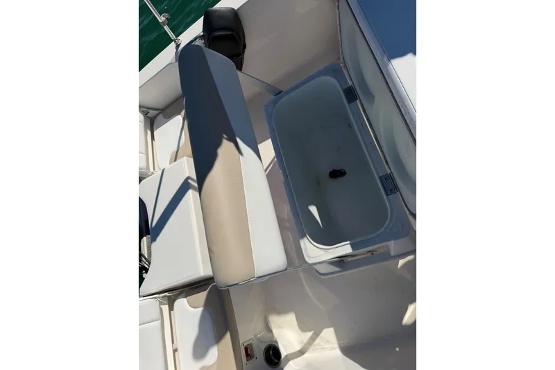 Slide: The Image of 2020 Robalo R160 Center Console boat interior with seating and storage compartment. - 28