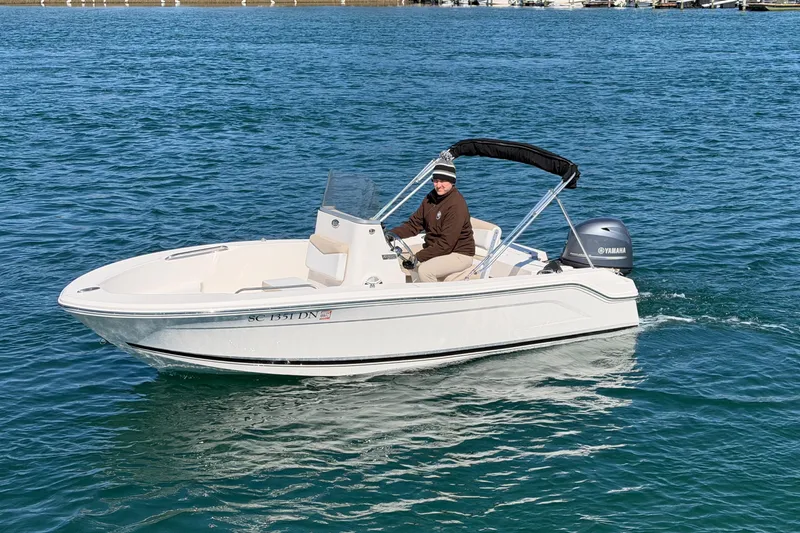 Slide: The Image of 2020 Robalo R160 Center Console boat on water with Yamaha engine. - 3