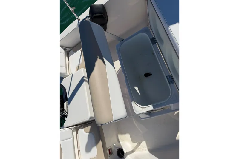 Slide: The Image of 2020 Robalo R160 Center Console boat interior with seating and storage compartment. - 33