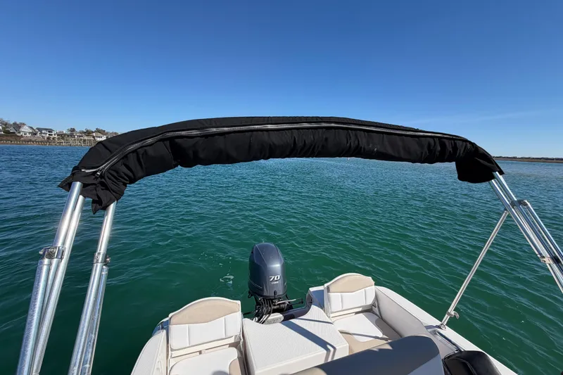 Slide: The Image of 2020 Robalo R160 Center Console boat on calm water with clear blue sky. - 34