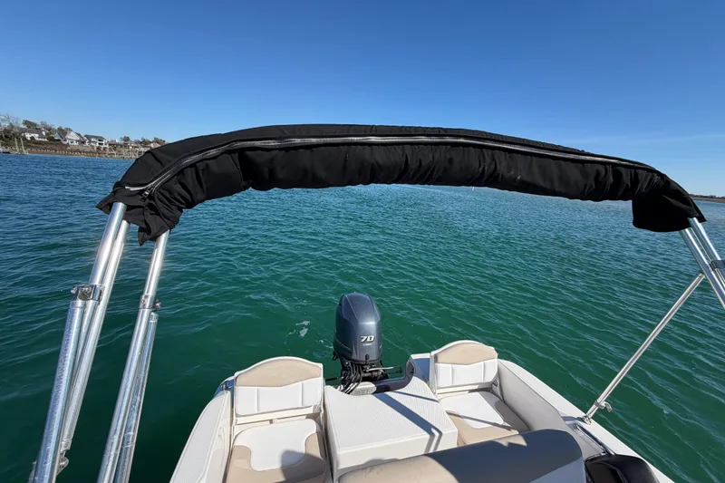 Slide: The Image of 2020 Robalo R160 Center Console boat on calm water with clear blue sky. - 35
