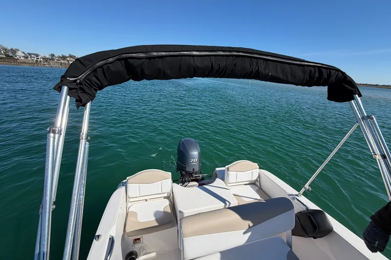 Slide: The Image of 2020 Robalo R160 Center Console boat on calm water with a clear blue sky. - 37