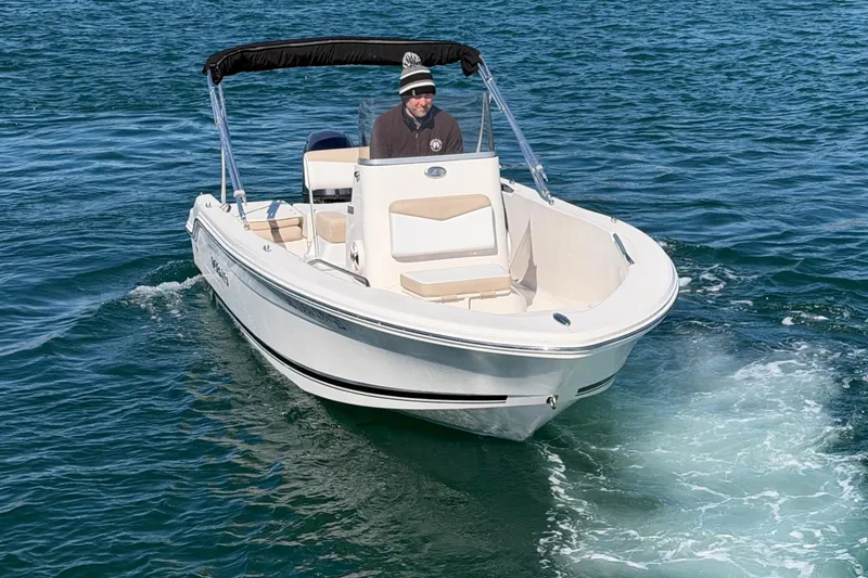 Slide: The Image of 2020 Robalo R160 Center Console boat cruising on open water. - 6