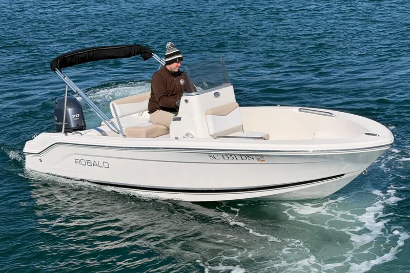 Slide: The Image of 2020 Robalo R160 Center Console boat cruising on open water. - 8