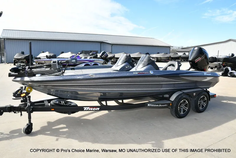 Slide: The Image of 2022 Triton 19 TRX PATRIOT boat on trailer outdoors. - 28