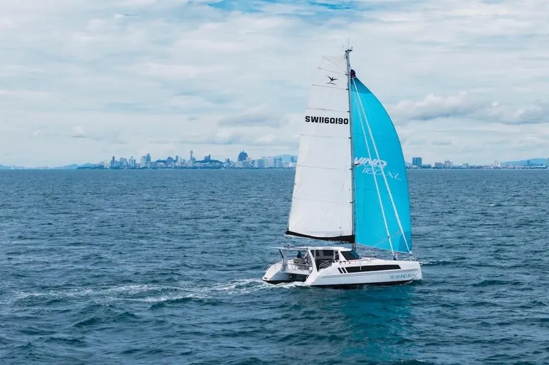 The Image of 2026 Seawind 1160XL catamaran sailing near a city skyline on a clear day. - 0