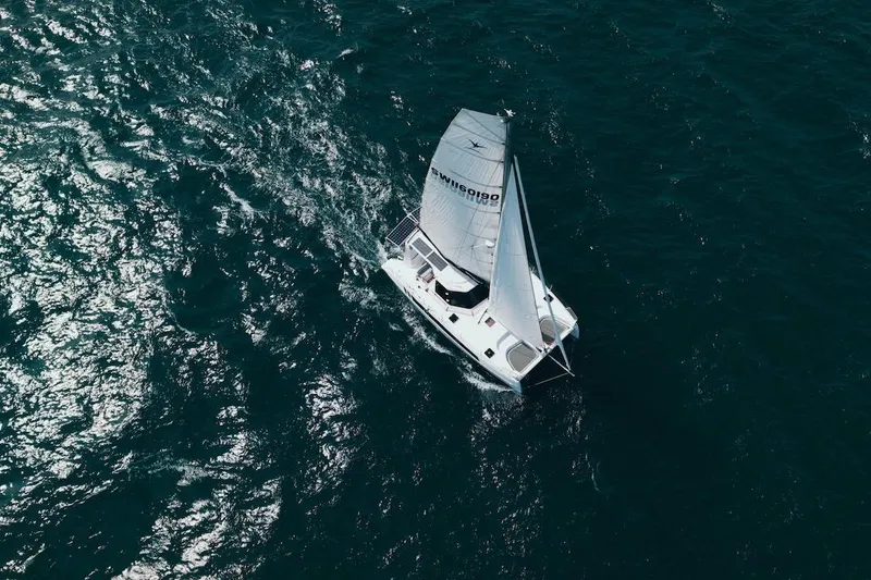 Slide: The Image of Aerial view of 2026 Seawind 1160XL catamaran sailing on open ocean waters. - 2