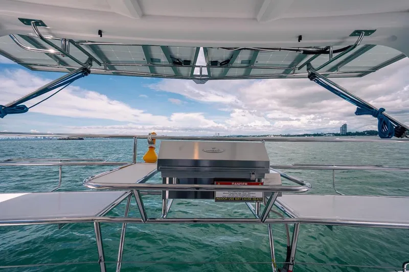 Slide: The Image of Seawind 1160XL 2026 catamaran with outdoor grill, ocean view, and solar panels. - 9