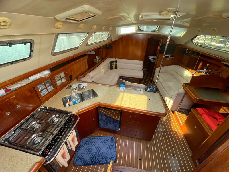 Slide: The Image of Interior of a 2007 Hunter 41 yacht with kitchen and seating area. - 12