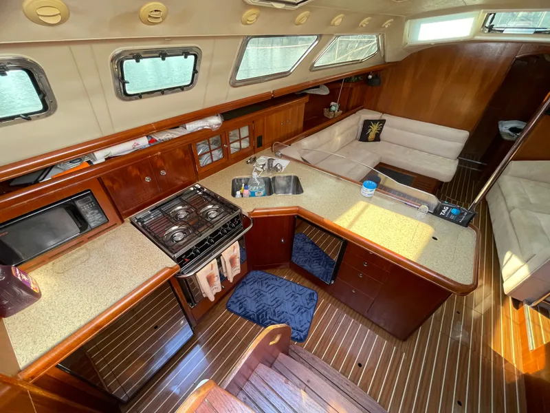 Slide: The Image of Interior of a 2007 Hunter 41 yacht with kitchen and seating area. - 15