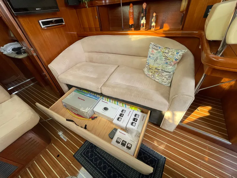Slide: The Image of Interior of a 2007 Hunter 41 yacht with storage under the sofa. - 17