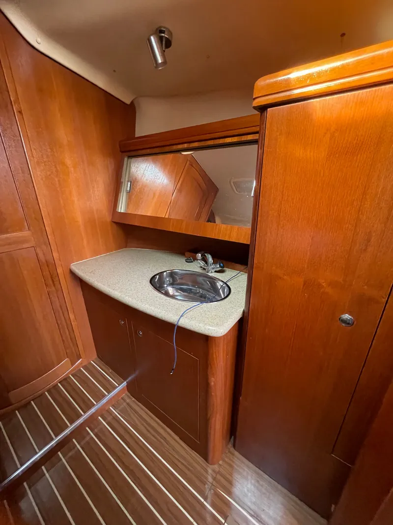 Slide: The Image of Interior of a 2007 Hunter 41 yacht with wood paneling. - 25