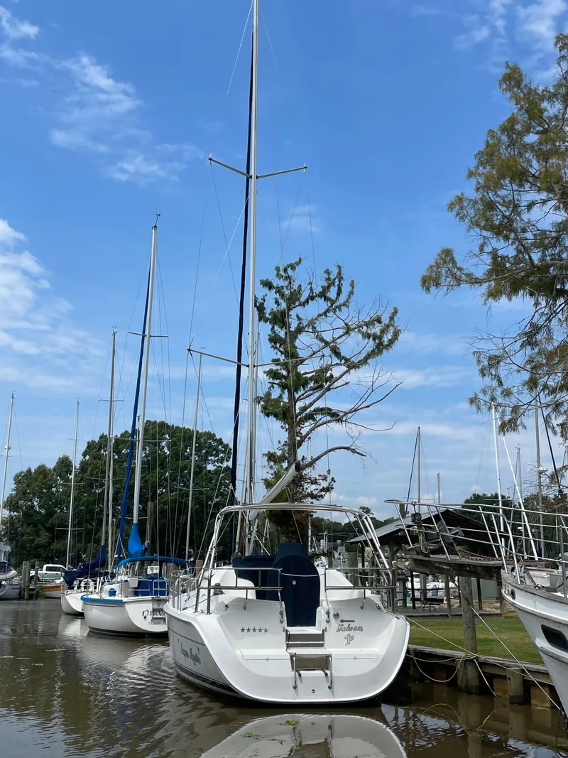 Slide: The Image of 2007 Hunter 41 sailboat docked on calm water. - 4