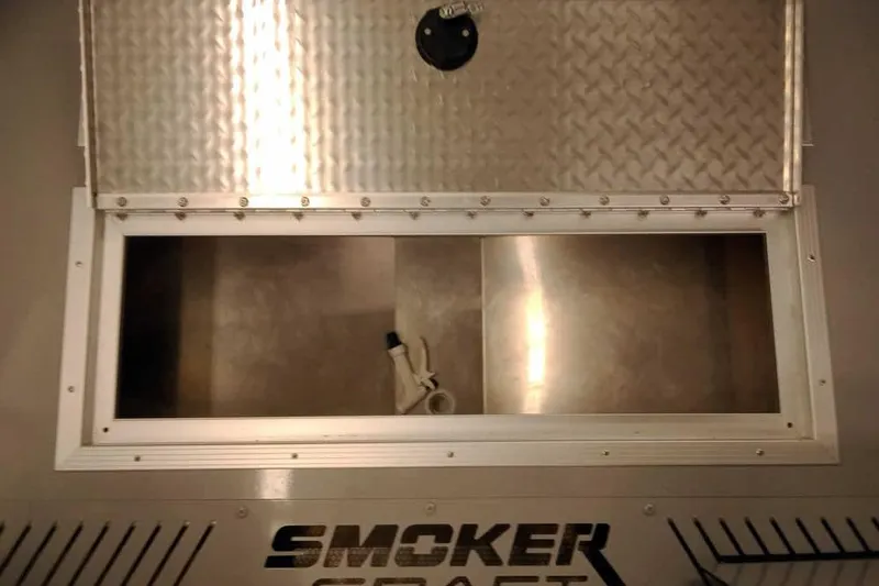 Slide: The Image of 2026 Smoker Craft Phantom 20 X2 Offshore boat storage compartment with open hatch. - 11