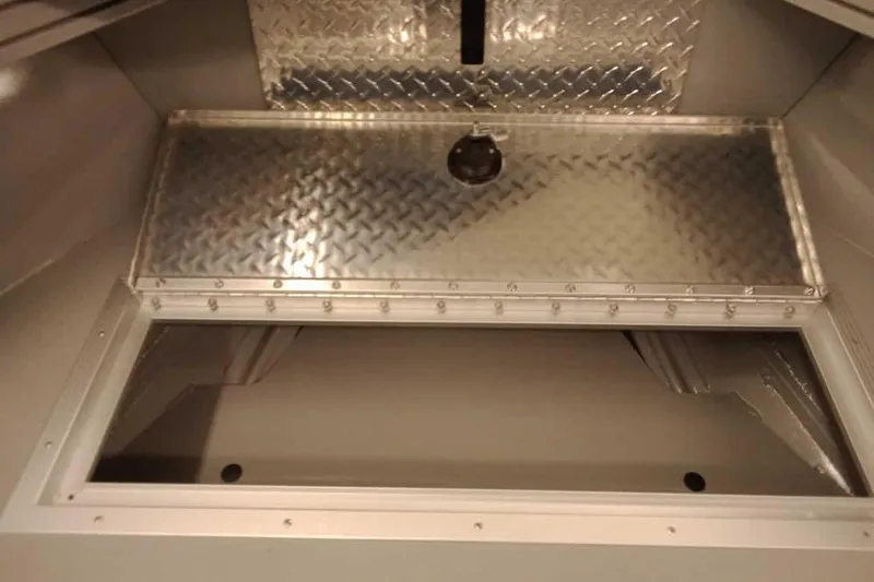 Slide: The Image of 2026 Smoker Craft Phantom 20 X2 Offshore boat storage compartment with diamond plate cover. - 12