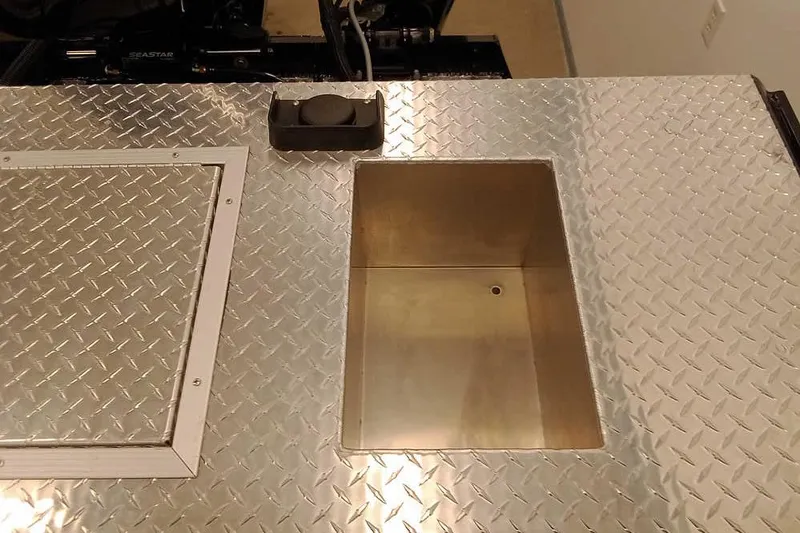 Slide: The Image of Aluminum deck of 2026 Smoker Craft Phantom 20 X2 Offshore boat with storage compartment. - 27