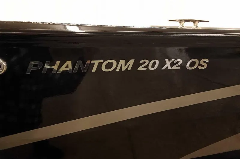 Slide: The Image of 2026 Smoker Craft Phantom 20 X2 Offshore boat nameplate on black surface. - 4