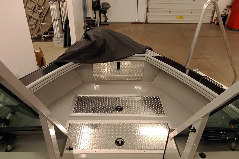 Slide: The Image of 2026 Smoker Craft Phantom 20 X2 Offshore boat interior with diamond plate flooring. - 8