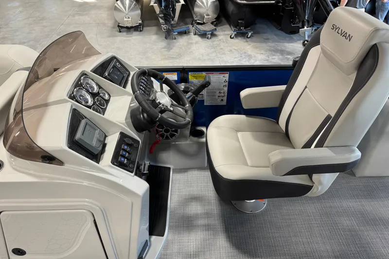 Slide: The Image of 2026 Sylvan X 5 boat interior with steering wheel and captain's chair. - 13