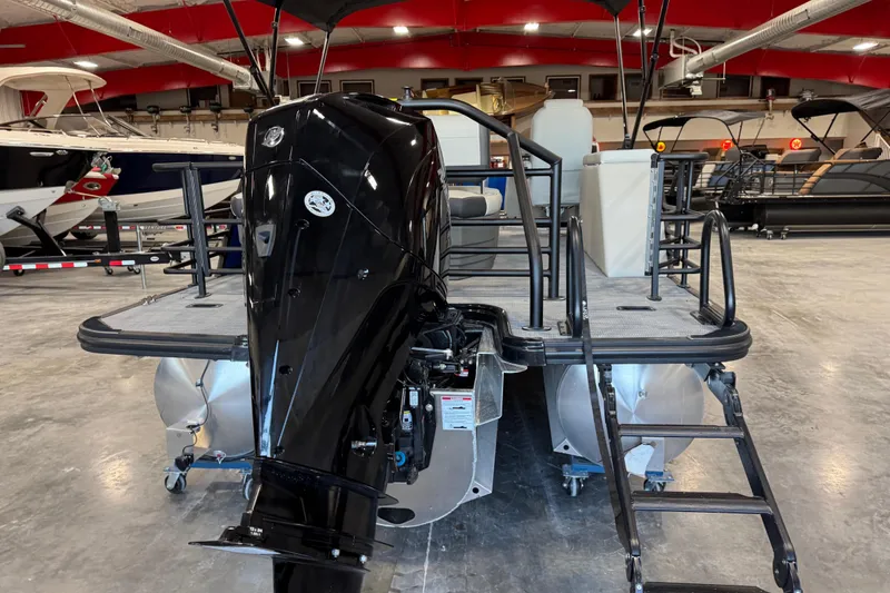 Slide: The Image of 2026 Sylvan X 5 pontoon boat with powerful outboard motor in showroom. - 4