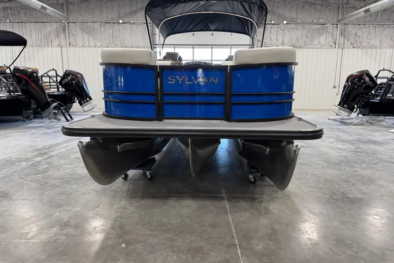 Slide: The Image of 2026 Sylvan X 5 pontoon boat in showroom, featuring blue exterior and modern design. - 5