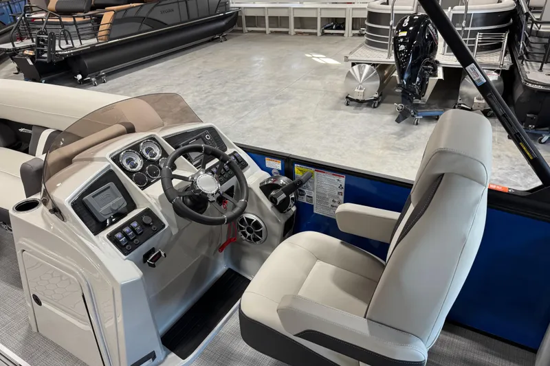 Slide: The Image of 2026 Sylvan X 5 boat interior with steering console and captain's chair. - 8
