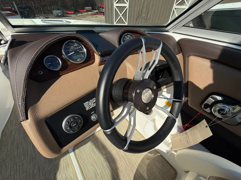 Slide: The Image of Steering wheel of a 2015 Cobalt 220S boat, close-up. - 16
