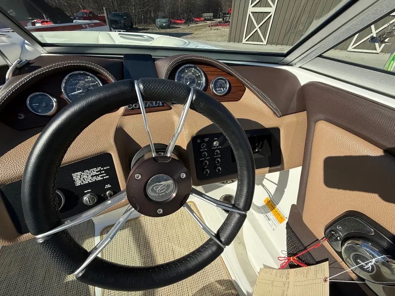 Slide: The Image of Steering wheel and dashboard of a 2015 Cobalt 220S boat. - 17