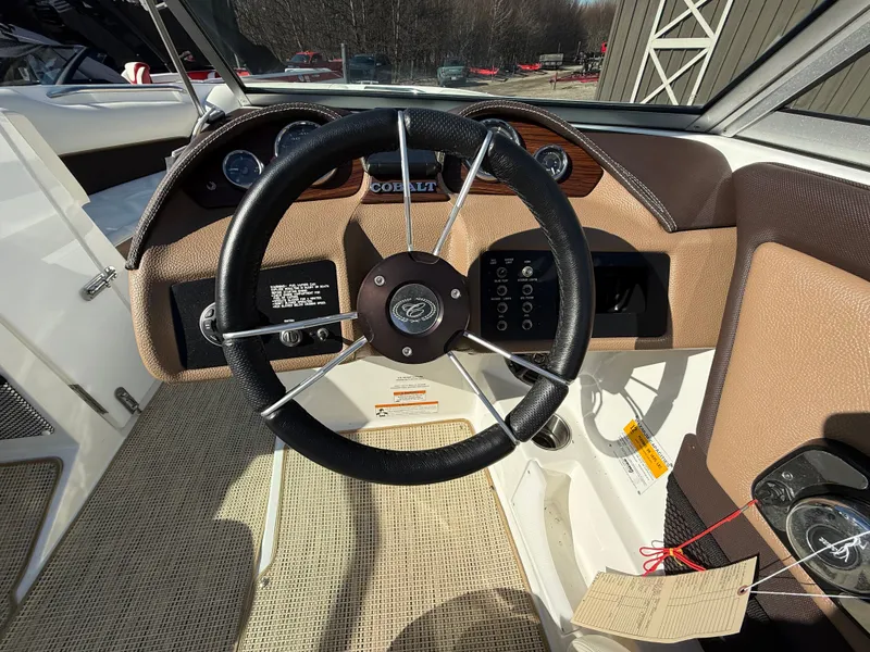 Slide: The Image of Steering wheel of a 2015 Cobalt 220S boat with dashboard. - 18