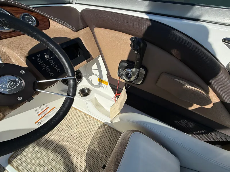 Slide: The Image of Interior of a 2015 Cobalt 220S boat with steering wheel and control console. - 19