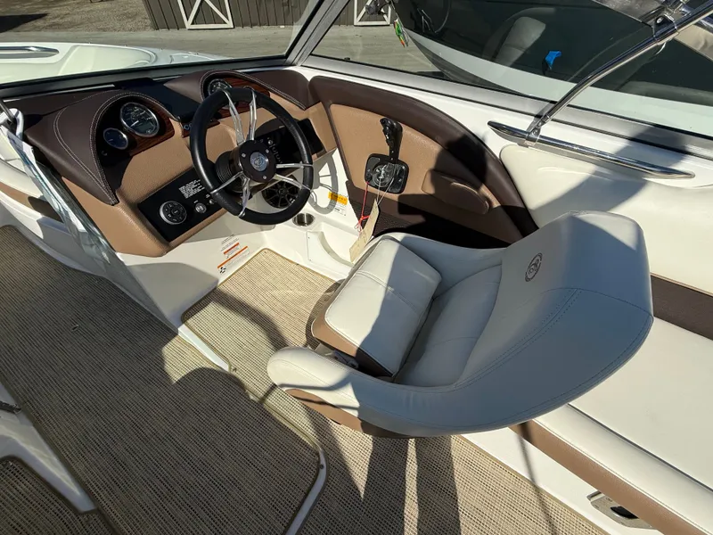 Slide: The Image of Interior of a 2015 Cobalt 220S boat with steering wheel and seat. - 20