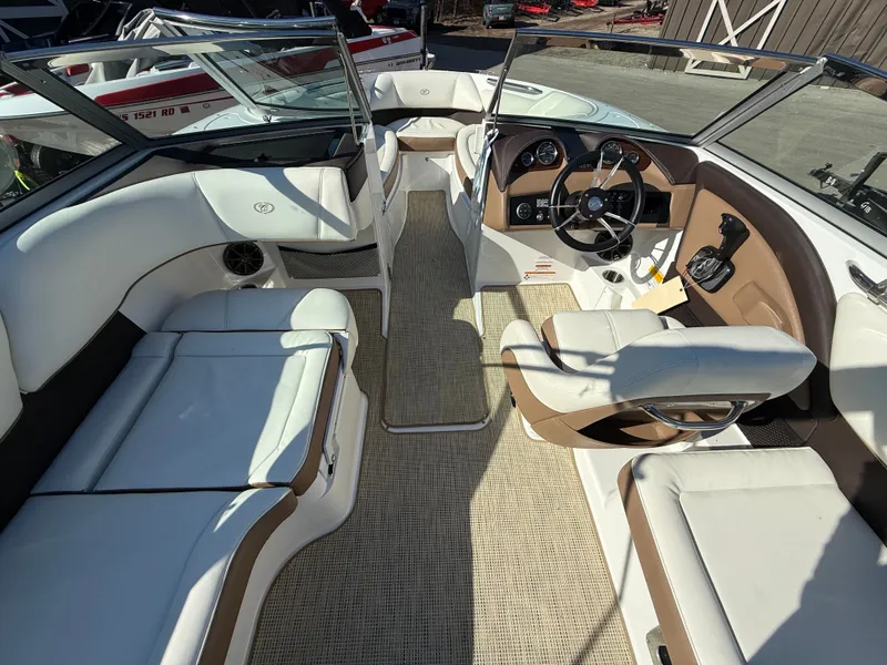 Slide: The Image of Interior of a 2015 Cobalt 220S boat with white and brown seating. - 31