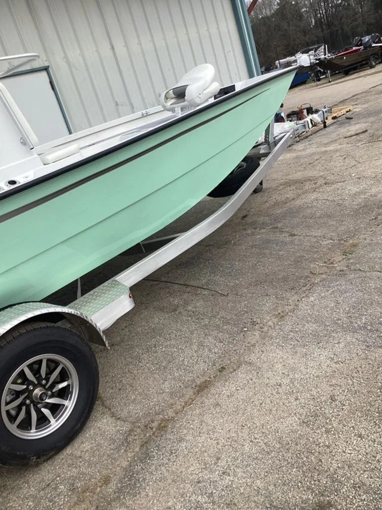 Slide: The Image of 2025 G3 Bay 21 GX boat on trailer, green. - 36