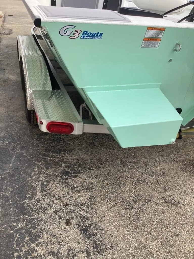 Slide: The Image of Rear view of a 2025 G3 Bay 21 GX boat on trailer. - 38