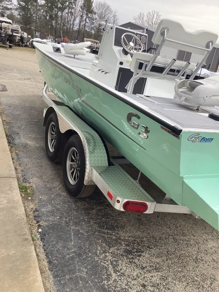 Slide: The Image of 2025 G3 Bay 21 GX boat on trailer, green. - 6