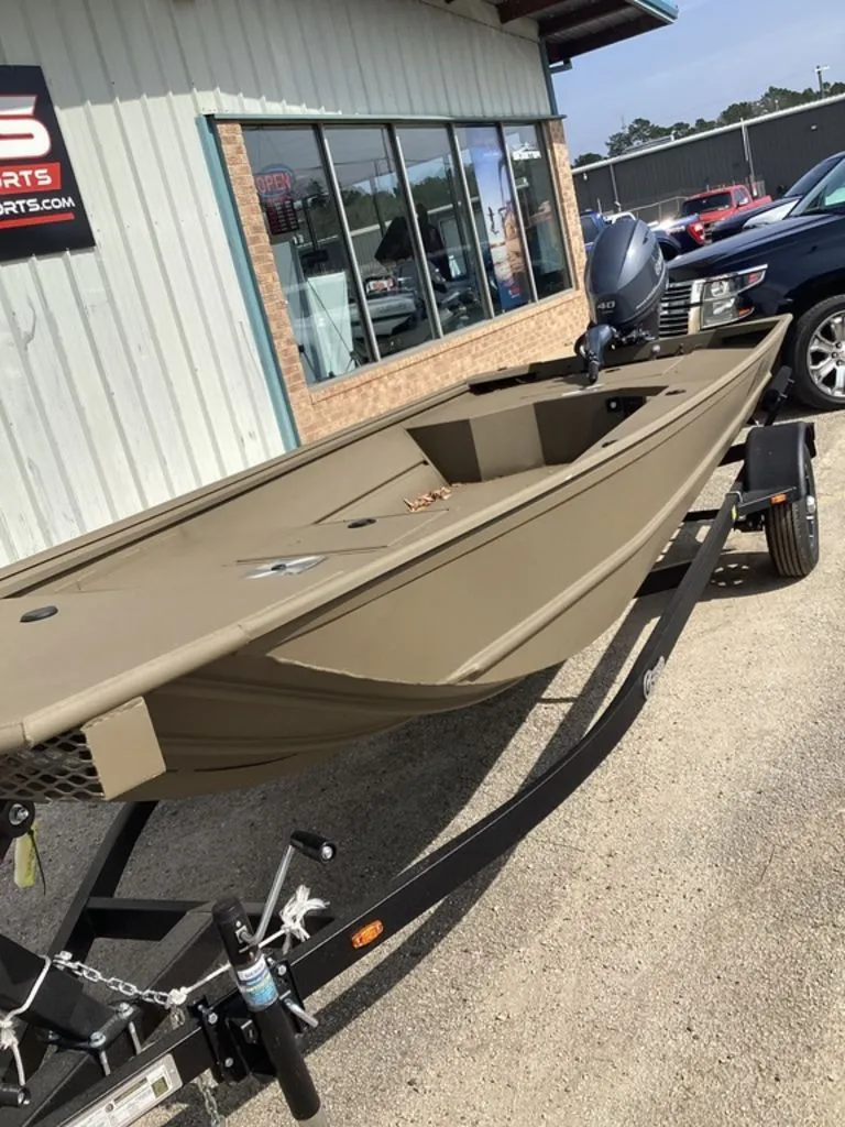 Slide: The Image of 2026 G3 Gator Tough 16 DK boat on trailer outside store. - 14