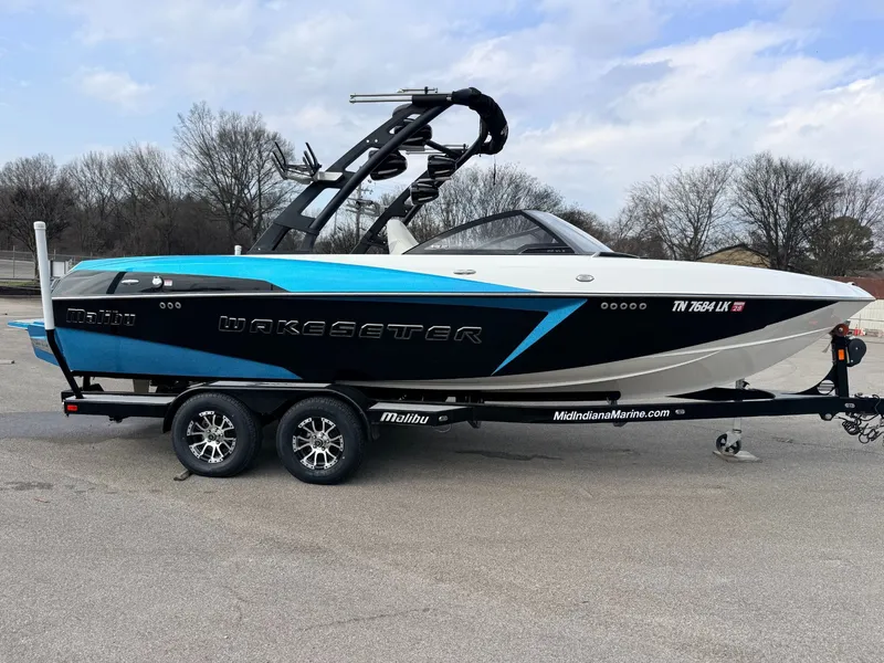 Slide: The Image of 2016 Malibu Wakesetter 22 VLX boat on trailer, blue and black. - 2