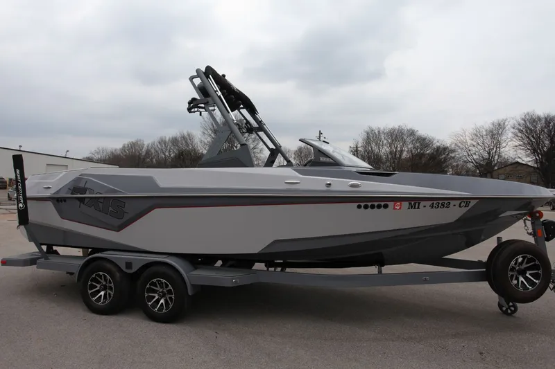 Slide: The Image of 2021 Axis T23 boat on trailer, gray color. - 2