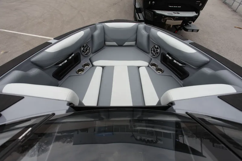 Slide: The Image of Interior of Axis T23 boat, gray and white upholstery, speakers, and cup holders. - 3