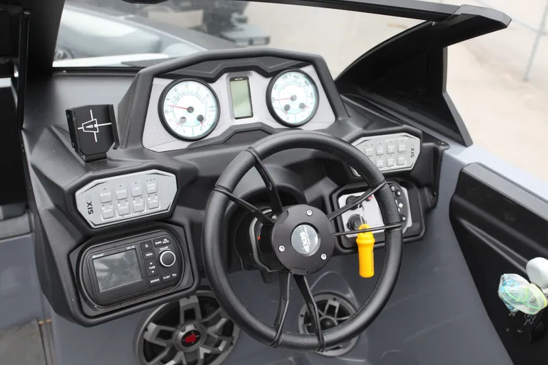 Slide: The Image of Steering wheel and dashboard of a 2021 Axis T23 boat. - 4