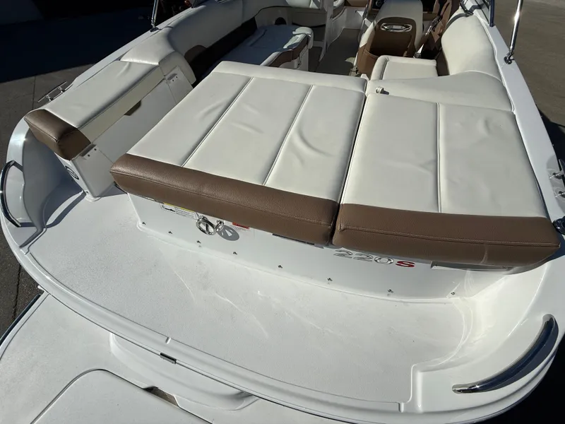 Slide: The Image of Interior of a 2015 Cobalt 220S boat with white and brown seating. - 12